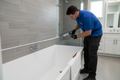 Professional caulking around bathtub and shower